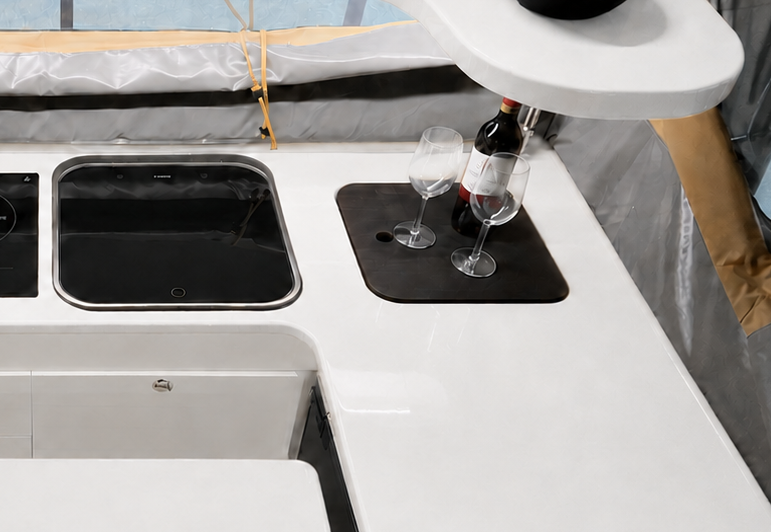 Black chopping board fitted into the galley benchtop