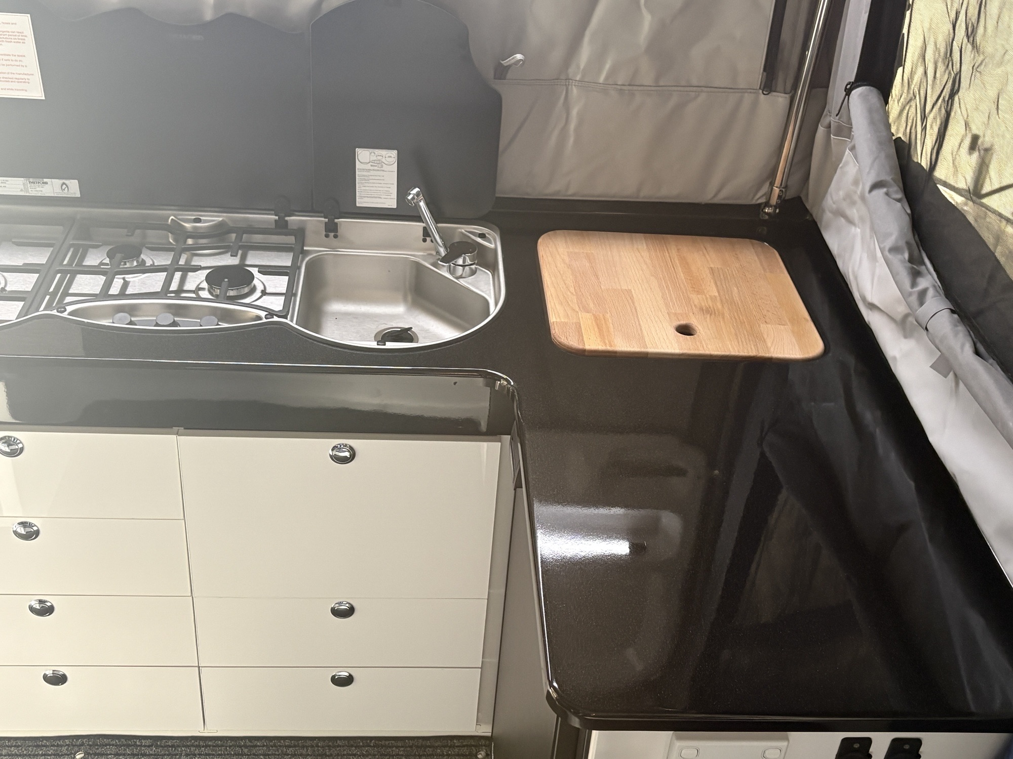 Natural timber chopping board fitted beside the galley